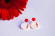 Red white earrings with red flower. Fashion jewelry background.