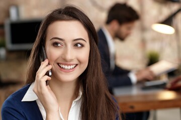 Sticker - Closeup portrait of attractive young businesswoman talking on mobilephone, looking away, smiling.