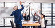 © Art_Photo - Successful group of casual business relaxing and throwing paper in modern work loft.Creative business people celebrating with arms up.Teamwork and success concept