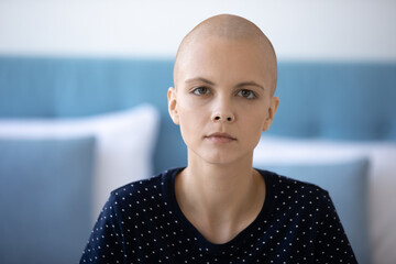 Wall Mural - Head shot portrait unhappy exhausted hairless young woman with oncology diagnosis looking at camera, hopeless unhealthy bald female patient suffering from cancer, healthcare and treatment concept