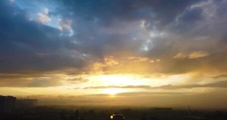 Wall Mural - Time lapse of city sunset sky with mist and fog covering city and buildings. 4K timelapse clip