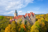 Aerial view of Czocha Castle surrounded by autumn yellow trees, Poland
