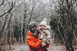 © Максим Галінский - Happy loving family! Father and his daughter playing and hugging outdoors. Lovely little girl and dad on a winter walk in nature. Frosty winter season concept.