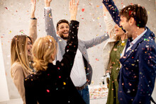 Group Of Business People Celebrating And Toasting With Confetti Falling In The Office