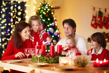 Wall Mural - Family with kids having Christmas dinner at tree