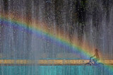 Fototapeta Tęcza - Rosd to happiness. A child rides a bicycle to a rainbow.