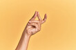 Arm and hand of caucasian man over yellow isolated background snapping fingers for success, easy and click symbol gesture with hand