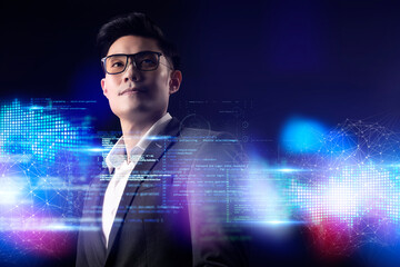 Wall Mural - Man and digital technology, Asian CEO business man standing smile, cyber digital screen in colorful light dark blue futuristic artificial intelligence coding background. 