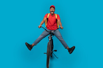 Wall Mural - Funny delivery delivery man riding bicycle at studio