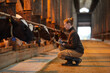 © Seventyfour - Side view portrait of young woman inspecting livestock and writing on clipboard while working at animal farm, copy space