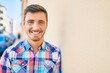 © Krakenimages.com - Young caucasian man smiling happy leaning on the wall at the city.