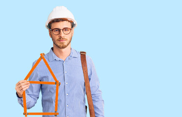 Handsome young man with bear wearing architect hardhat holding build project thinking attitude and sober expression looking self confident