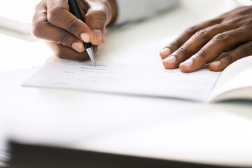 Wall Mural - African American Writing Cheque. Signing Paycheck