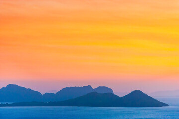 Wall Mural - mountain landscape on sunset sea with colorful sunset sky