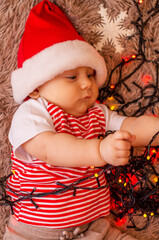 Wall Mural - baby in santa hat wish you a merry christmas and happy new year