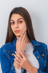 Beautiful woman natural young female long black hair showing yours hands and nails. Young woman looking the camera.