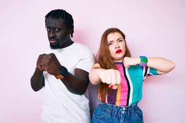 Poster - Interracial couple wearing casual clothes punching fist to fight, aggressive and angry attack, threat and violence