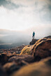 Solo traveler Woman standing on cliff relaxing mountains and clouds aerial view Love and Travel happy emotions Lifestyle concept. Young female traveling active adventure vacations. Landscape Iceland