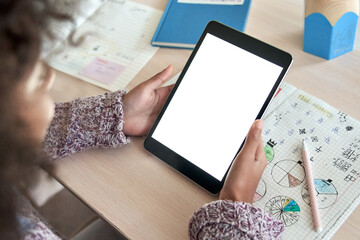 African american elementary school girl student distance learning online at home, elearning, watching web class holding digital tablet. Virtual education. Over shoulder close mock up screen view.