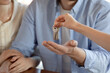 © fizkes - Keys from new independent life. Close up shot of young spouses making deal contract and receiving keys of purchased rented leased dwelling from female real estate dealer, seller, broker or homeowner
