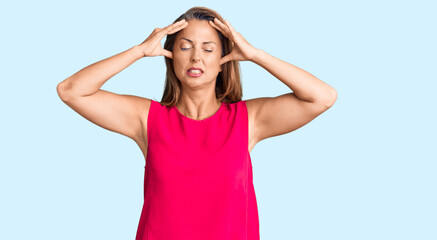 Canvas Print - Middle age hispanic woman wearing casual clothes suffering from headache desperate and stressed because pain and migraine. hands on head.