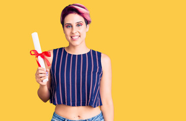 Sticker - Young beautiful woman with pink hair holding graduate degree diploma looking positive and happy standing and smiling with a confident smile showing teeth