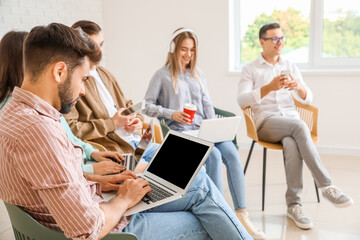 Wall Mural - Students with modern devices studying online indoors