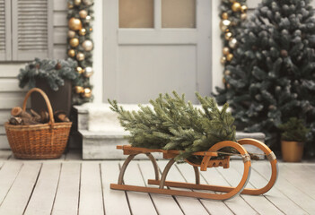 House christmas retro decorations in gold and silver colors. Sled with tree