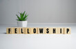 Fellowship concept - Fellowship word on wooden cubes