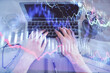 © peshkova - Multi exposure of man's hands typing over computer keyboard and forex graph hologram drawing. Top view. Financial markets concept.