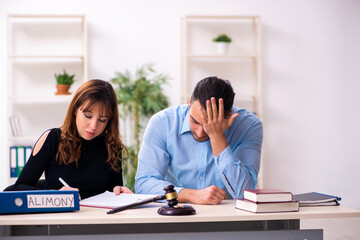 Wall Mural - Young couple divorcing in alimony concept