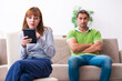 © Elnur - Young couple in gadget dependency concept