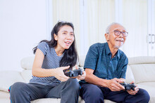 Happy Woman Plays Video Games With Her Father