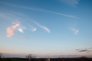 Wall Mural - the clouds in the sky are lit up by the rays of the setting sun. landscape