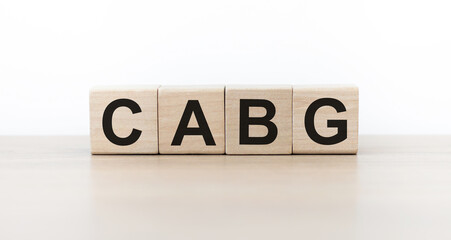 Wall Mural - cubes with the word CABG on them. Care concept.