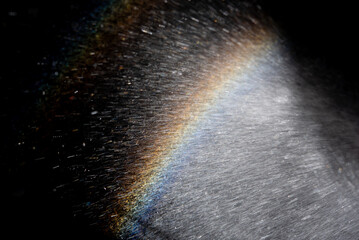 Rainbow in water sparks on dark background