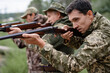 © freeograph - Hunters Standing in Line Shooters Taking Aim.