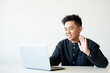 © golubovy - Online interview. Virtual meeting. Business webinar. Cheerful asian guy greeting team on laptop camera smiling isolated on white copy space background.
