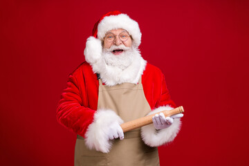 Wall Mural - Photo of crazy stylish modern grey bearded santa claus hold rolling pin x-mas christmas meal preparation wear apron red costume isolated bright shine color background