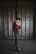 © Halfpoint - Portrait of blond teenager girl standing indoors in abandoned building.