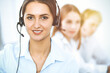 © rogerphoto - Call center. Focus on beautiful business woman in headset