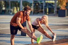 Young Adult Sporty Couple Working Out Outdoors In Urban Surroundings.