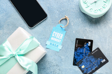 Poster - Gift box with credit cards, mobile phone, alarm clock and shopping tag with text CYBER MONDAY SALE on color background