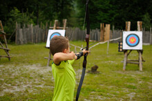 Boy At Archery With Bow And Arrow