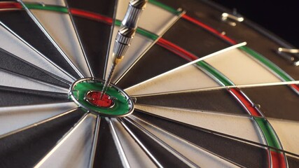 Poster - Clockwise rotating Dart Board with dart in Bullseye.