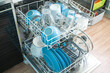 © Alex Kukina - opened Dishwasher after cleaning process both baskets with clean dishes: bowls, glasses