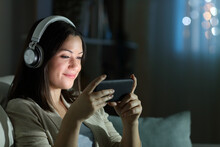 Relaxed Woman Watching Video In The Night At Home