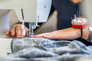 sewing cloth on a sewing machine in a tailor shop