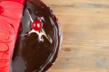 Poster - delicious cake with cherries and chocolate cream on wood table