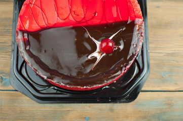 Canvas Print - delicious cake with cherries and chocolate cream on wood table